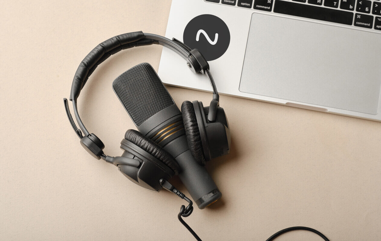 Dynamic microphone with headphones and laptop.